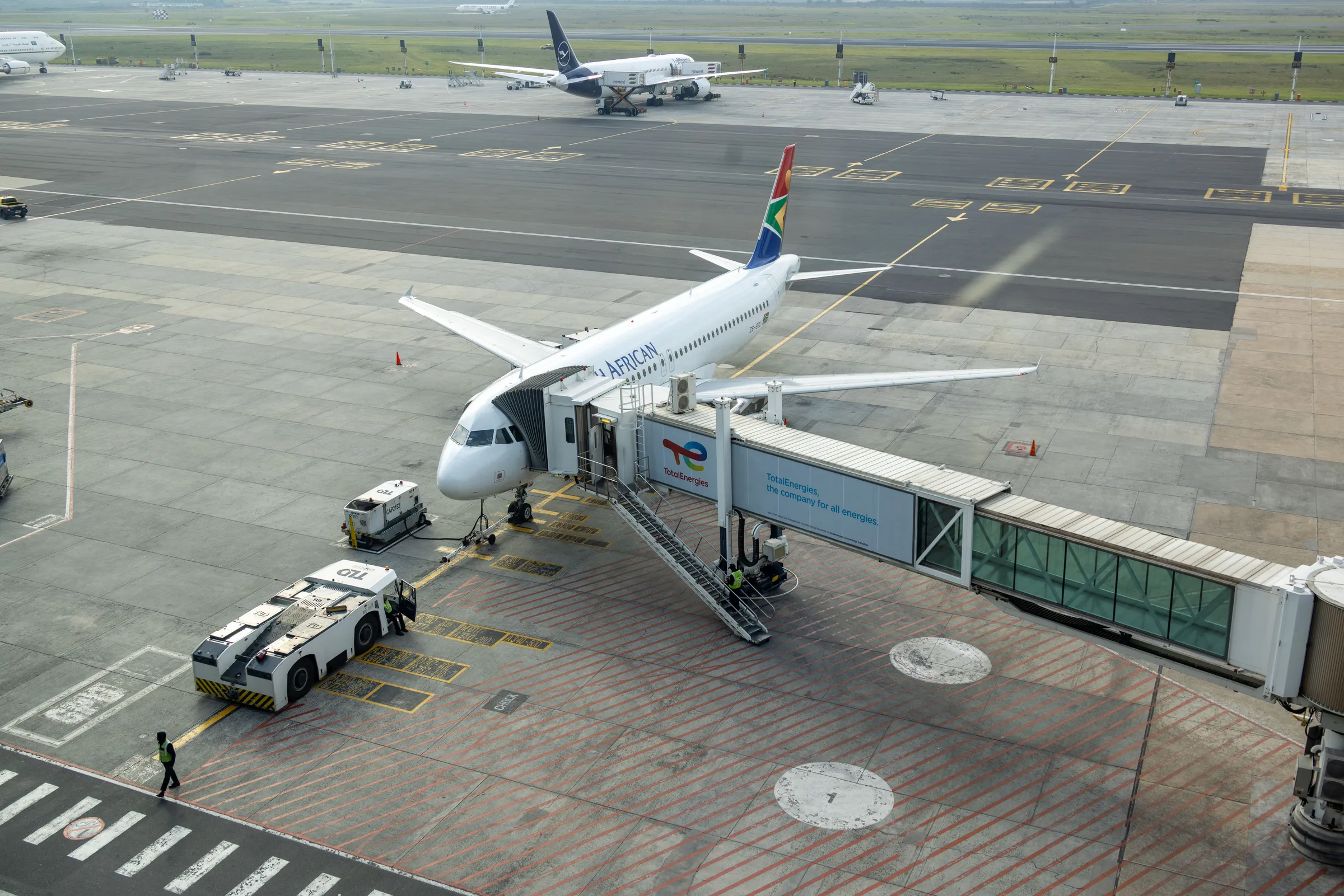 A South African Airways jet at a gate on an airport apron