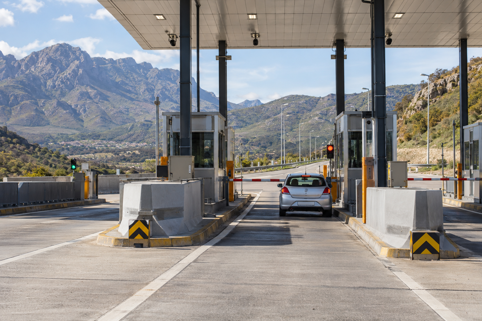 Illustrative toll plaza with a car waiting at a barrier