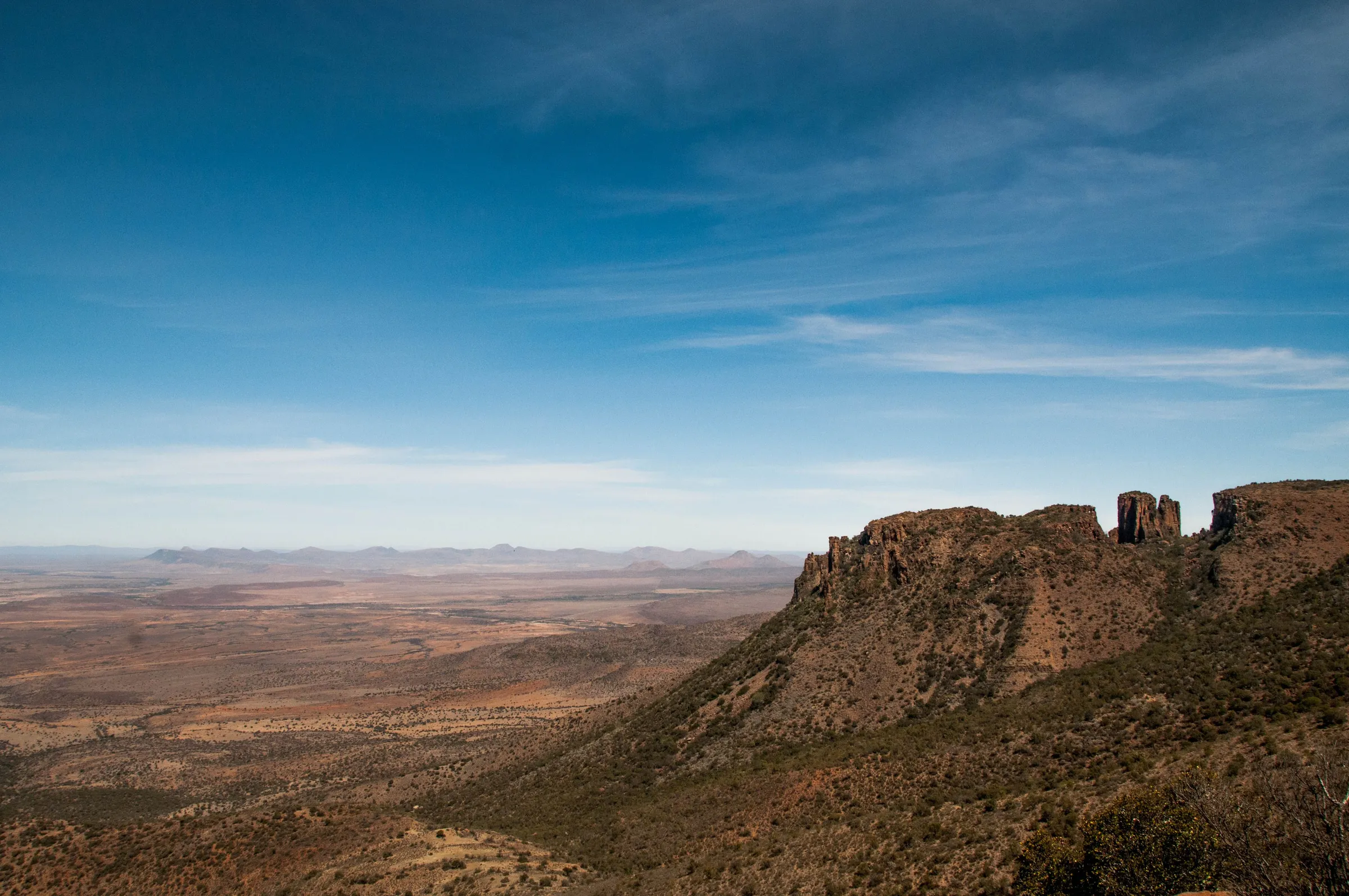 A rock outcrop above a wide, dry valley
