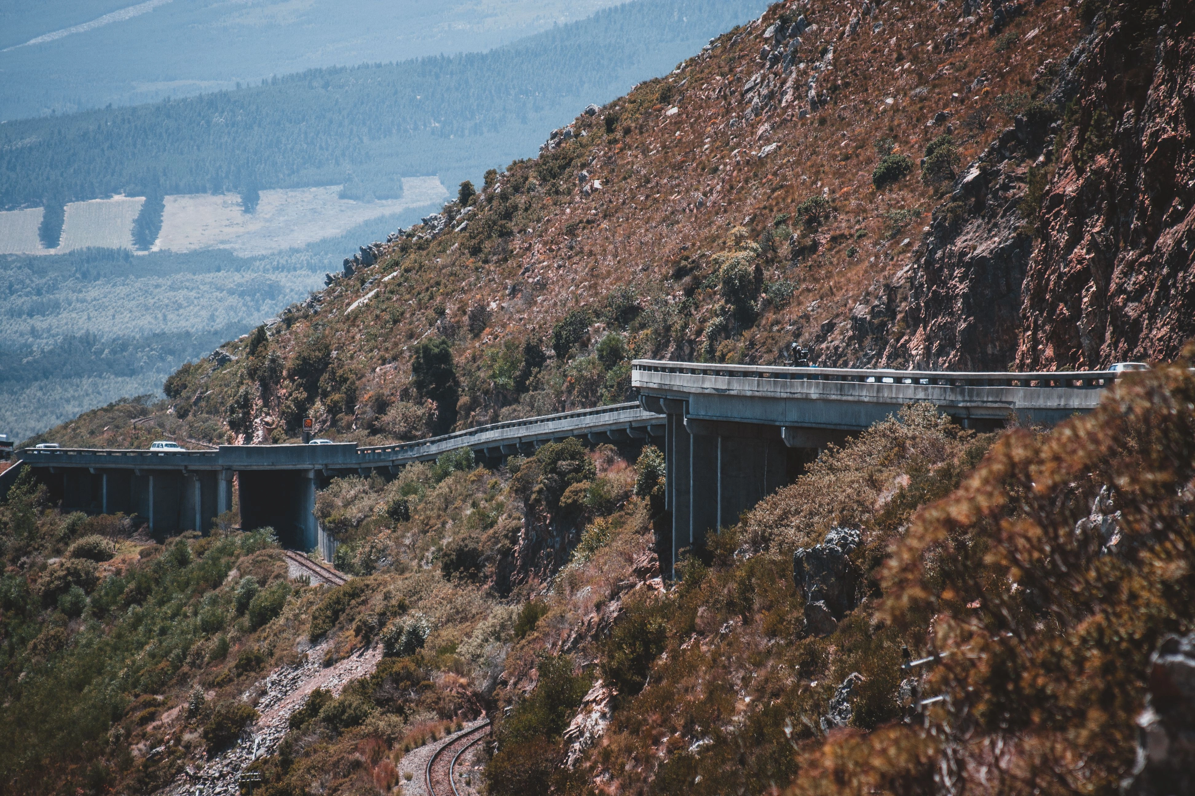 A mountain highway curving above a wooded valley in South Africa